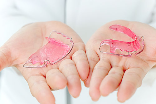 Dentist holding Retainer, Orthodontics Dental concept background